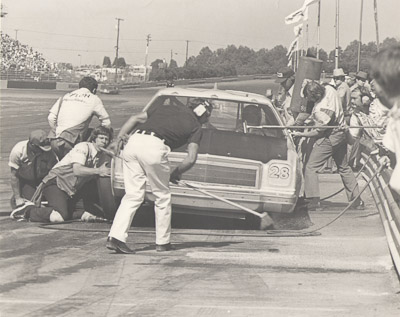 nascar pit stop charlotte motor speedway early 1970's tire changer windshield washer gas man
